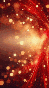 a red and gold background with a lot of sparkles
