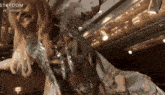 a woman in a stardom costume is smiling and dancing