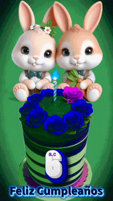 two rabbits sitting on top of a cake that says feliz cumpleaños