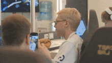 a man in a white shirt with the letter g on it