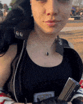 a woman wearing a black tank top has a patch on her sleeve that says ' enforcement '