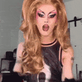 a drag queen is wearing a black tank top with a zebra print on it