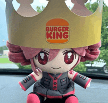 a stuffed doll wearing a crown that says burger king on it