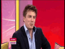 a man in a suit and blue shirt is on a lorraine show at 9:00