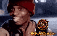 a man wearing a red beanie is smiling next to a logo that says inkarnate