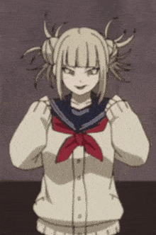 a girl with blonde hair and a red scarf is wearing a sailor uniform .