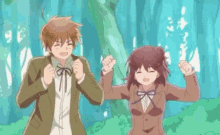a boy and a girl are standing next to each other in a forest with trees in the background