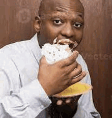 a man is eating a piece of cake from a yellow plate .