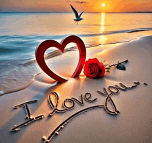 a heart and a rose on the beach with the words i love you written in the sand