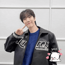 a man wearing a rex black aces jacket
