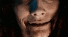 a close up of a woman 's face with blood coming out of her mouth and nose .