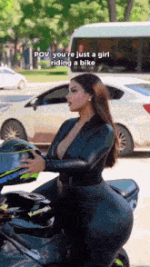 a woman is sitting on a kawasaki motorcycle holding her helmet .