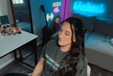 a woman wearing a shirt that says hustle and flow