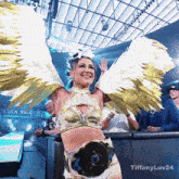 a woman in a costume with wings and the words tiffanyluv24 on the bottom right