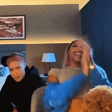 a group of people are sitting on a couch in a room .