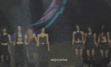 a group of women are dancing on a stage with the words onlyryurina on the bottom right