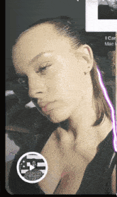 a woman in a black tank top has a picture of a man in a plaid shirt on her chest