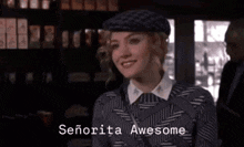 a woman wearing a beret and a sweater is smiling and saying `` señorita awesome '' .