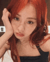 a woman with red hair is taking a selfie
