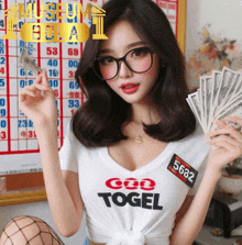 a woman wearing a shirt that says ' god togel ' on it holds a bunch of money