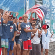 a man wearing a usa shirt stands in front of a group of people