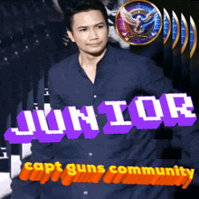 a man in a blue shirt stands in front of a sign that says junior