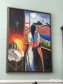 a framed painting of a woman holding a baby in her arms