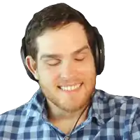 a man wearing headphones smiles with his eyes closed