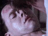 a close up of a man 's face with a woman kissing him