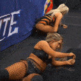 a woman squatting in front of a aew banner