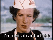 a man wearing a chef 's hat and an apron says i 'm not afraid of joe