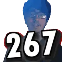 a man with glasses holds up the number 267 in front of his face