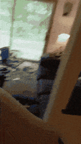 a blurred image of a person 's arm holding a piece of wood