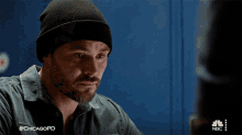 a man wearing a beanie and a green shirt with #chicagopd