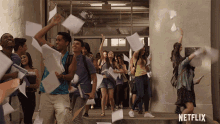 a group of people throwing papers in the air with a netflix logo in the background
