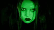 a woman with green eyes and black lipstick