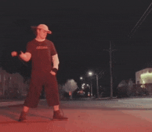 a man is standing on a street with the words " dye brushes red " on the ground