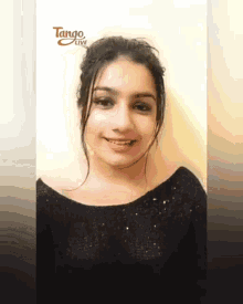 a woman is smiling in front of a tango live ad