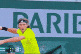 a tennis player is swinging a tennis racket in front of a sign that says pa