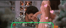 a man kissing a woman 's hand with a green border that says tamil music.com