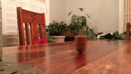 A dreidel spins on top of a table