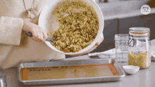 Granola being poured out on to prepared pan