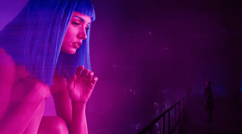 Animated character with blue hair in a neon-lit, futuristic city environment.