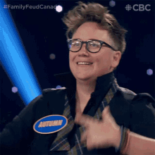 a woman wearing glasses and a name tag that says autumn is smiling and giving a thumbs up