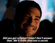 a man is smiling and talking about religion