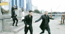 a group of men are walking down stairs with the word cherry on the bottom right