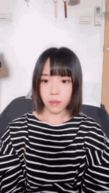 a girl wearing a black and white striped shirt