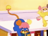 two cartoon characters are standing next to each other on a table . one of the characters has a long tail .