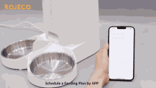 a person is using a phone to schedule a feeding plan for their pet