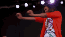 a woman in a red shirt is dancing in front of a purple background with the hashtag #sytvcdpreview